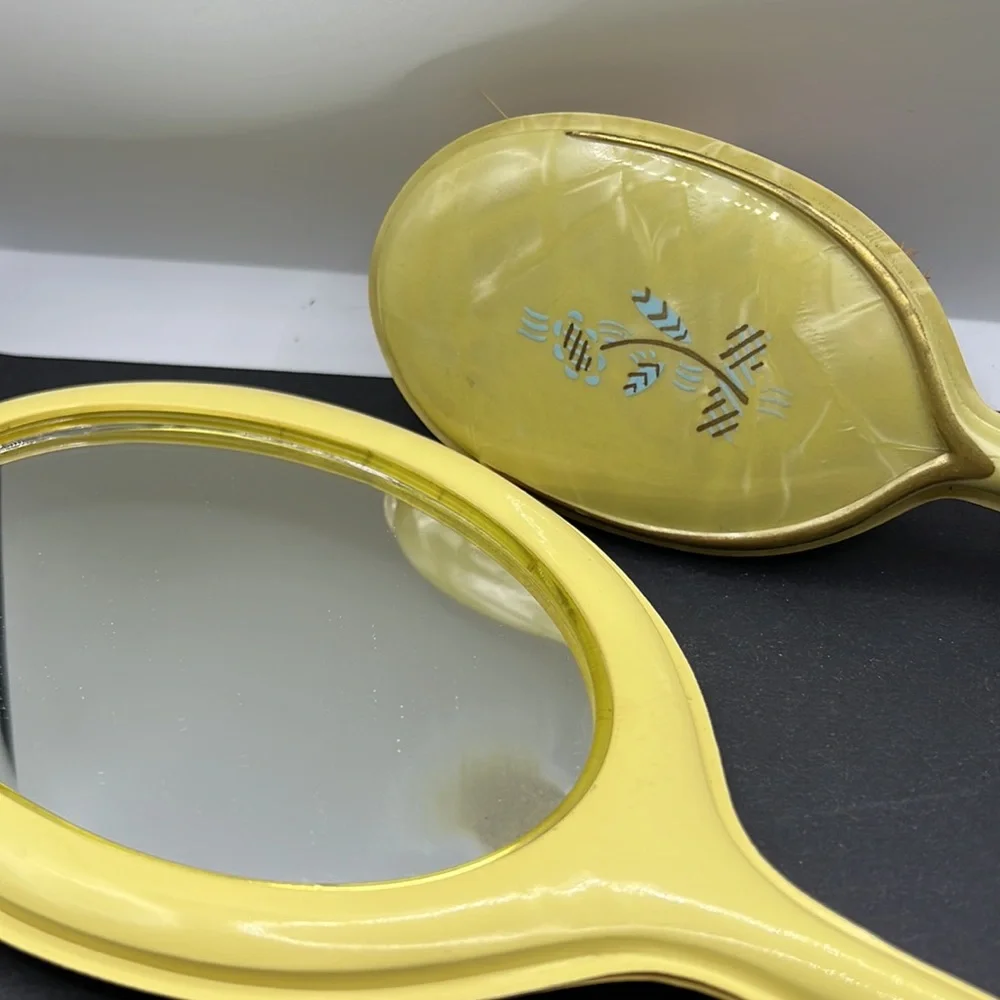 Vintage yellow celluloid vanity mirror, comb and brush set